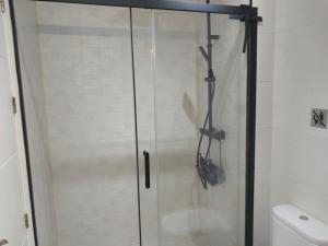 a shower with a glass door in a bathroom at Ático acogedor, céntrico y a 2 min de la playa. in Fuengirola +22 photos