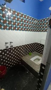 a bathroom with a toilet in a room at Pinddaan & Hotel Gaya dham in Gaya +9 photos