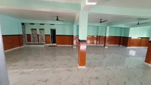 an empty room with blue and white walls and marble floors at Pinddaan & Hotel Gaya dham in Gaya