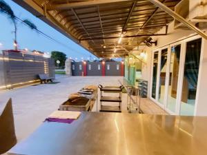 a patio with a large metal table and chairs at B02 Party House Bungalow 20 PAX in Johor Bahru