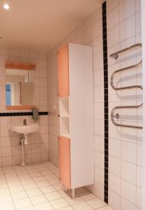 a bathroom with a sink and a shower at Tomelilla Golf Hotell in Tomelilla