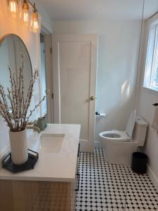 a bathroom with a white sink and a toilet at Charming Victoria Character Home-Pet Friendly in Victoria +14 photos