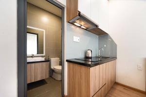 a bathroom with a sink and a toilet and a mirror at Daisy House Near Bui Vien - Self Checkin in Ho Chi Minh City +39 photos