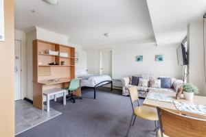 a living room with a couch and a bed at City center apartment with a view in Melbourne