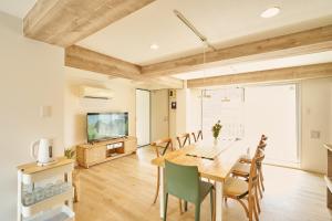 a dining room with a table and chairs and a tv at 25 min to Shibuya by Train 1 min to Sta 86 square meters in Kugayama