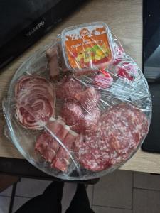 a tray of meat and vegetables on a table at Gîte avec jacuzzi privatif in Solre-le-Château +8 photos