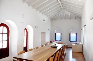 a dining room with a long wooden table and chairs at Pirgos Mavromichali in Limeni