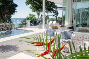 a glass house with a view of the ocean at Pool House, luxury 2 bedroom with ocean views, pool and sauna in Lennox Head