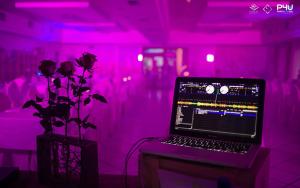 a laptop computer on a table in a room with pink lights at Hotel da Rita in Condino