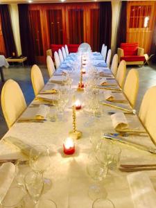 a long long table with wine glasses and napkins at Hotel da Rita in Condino