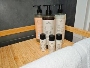 a group of four deodorant bottles sitting on a shelf at City Hall Bliss Suite - Premium Apartament z Balkonem i Widokiem na Ratusz in Kołobrzeg