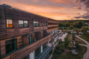 a building with a lot of windows on the side of it at Sonnenhotel Weingut Römmert Spa und Wellness in Volkach