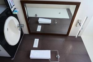 a bathroom with a sink and a mirror at Citrus plaza in Bengaluru
