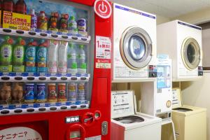 a soda vending machine in a store with drinks at サンホテル大間 in Ōma