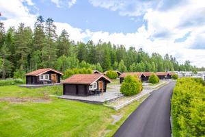 a row of cottages on the side of a road at First Camp Haganäset - Charlottenberg in Åmotsfors