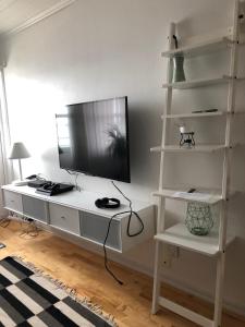 un escritorio blanco con TV encima en Central seaview apartment with balcony, en Tromsø