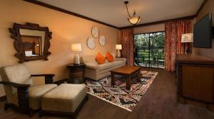 a living room with a couch and a mirror at Disney's Animal Kingdom Lodge in Orlando