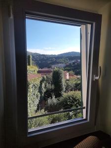 a window with a view of a mountain at SECRET GARDEN-bike-friendly home-MANDARANCIO in Calice Ligure +65 photos