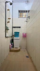 a bathroom with a toilet in a tiled room at Malaika Homestay in Alor Setar +9 photos