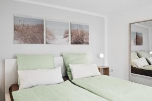 a bedroom with two beds and a mirror at Ferienhaus für Mensch & Hund mit großer Terrasse in Andernach