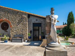 a statue of a woman standing in front of a building at Le Cocon in Villalier