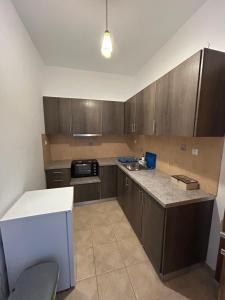 a kitchen with wooden cabinets and a counter top at MARGARITA'S-STUDIOS in Koufonisia +14 photos