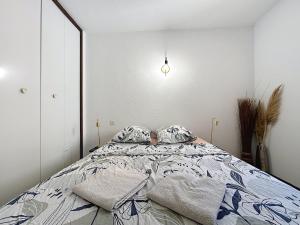a bedroom with a bed with two pillows on it at Le Luxembourg - Appartement proche des Halles - Wifi in Narbonne