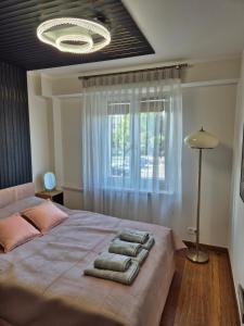 a bedroom with a large bed with towels on it at Silver Chopin Apartment 15 Lubartów in Lubartów