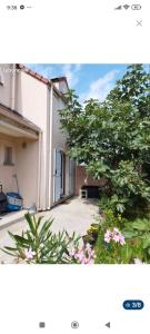 a picture of a house with a tree and flowers at Studio cosy proche aéroport d'Orly & paris in Paray-Vieille-Poste
