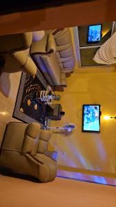 a living room with a couch and a tv at Prisca home news 