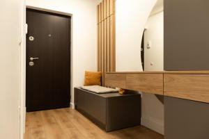 a bathroom with a vanity and a mirror at Nest Inn Emerald Apartment in Baia Mare +4 photos