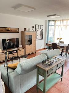 a living room with a couch and a table at El Rincón de la Playa in Mogro