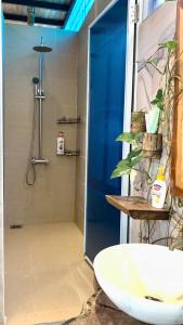 a bathroom with a shower and a white sink at Đà Lạt in Phú Quốc Homestay - Free Airport Pickup for 4 night bookings in Phu Quoc +15 photos