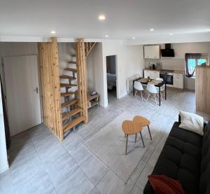 a living room with a couch and a table at La petite maison de Chéu in Chéu