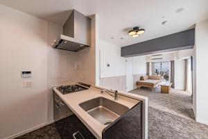 a kitchen with a sink and a stove at Apartment Hotel 11 Asakusa 1 in Tokyo