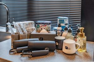 a kitchen counter with a sink and some bottles and cups at Apartment Hotel 11 Asakusa 1 in Tokyo
