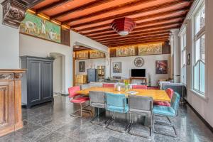 a dining room with a wooden table and chairs at Edam Suites in Edam