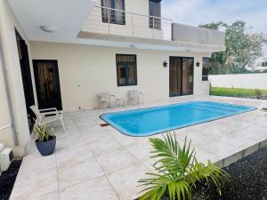 a swimming pool in the backyard of a house at Villa AmNa in Grand Baie