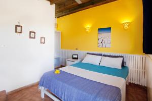 a bedroom with a bed and a yellow wall at Eldorado Lodge and Restaurant in Dahab +40 photos