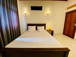 a bedroom with a large bed in a room at Villa 4C in Midigama +12 photos