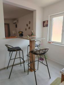 a kitchen with two bar stools and a counter at Passage in Paraćin