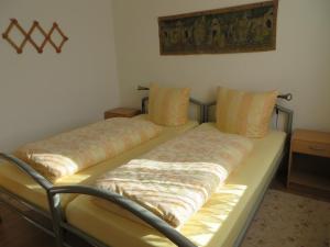 a bed with two pillows on it in a room at Ferienwohnung Zahn in Oelsnitz