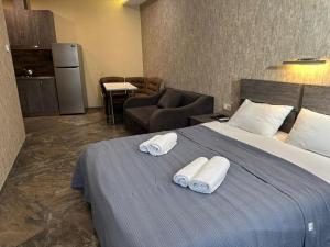 una camera d'albergo con un letto con asciugamani sopra di hotel Labyrinth pool a Tbilisi City Altre 94 foto
