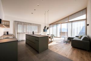 a kitchen and living room with a couch and a table at Florerhof in Schenna
