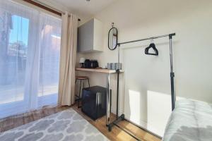 a bedroom with a bed and a desk and a window at Private Guesthouse in Manchester