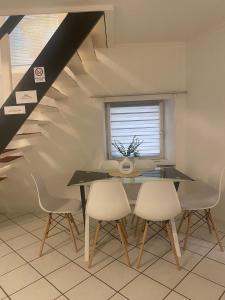 a dining room with a table and chairs and a window at Gästehaus Saarbrücken in Saarbrücken
