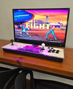 a computer monitor sitting on top of a desk at [New!] Jonker Street Loft 3BR Melaka 10PAX in Melaka