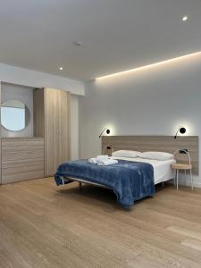 a bedroom with a bed with a blue blanket at Apartamentos Pillotegi parking gratuito in San Sebastián +75 photos