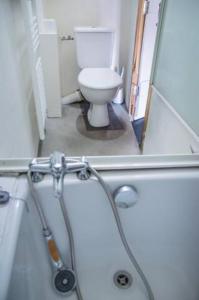a bathroom with a toilet and a bath tub at Maison de bourg Cébazat in Cébazat