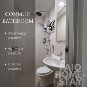 a bathroom with a sink and a toilet and a mirror at Faiq Homestay in Kuching +1 photo